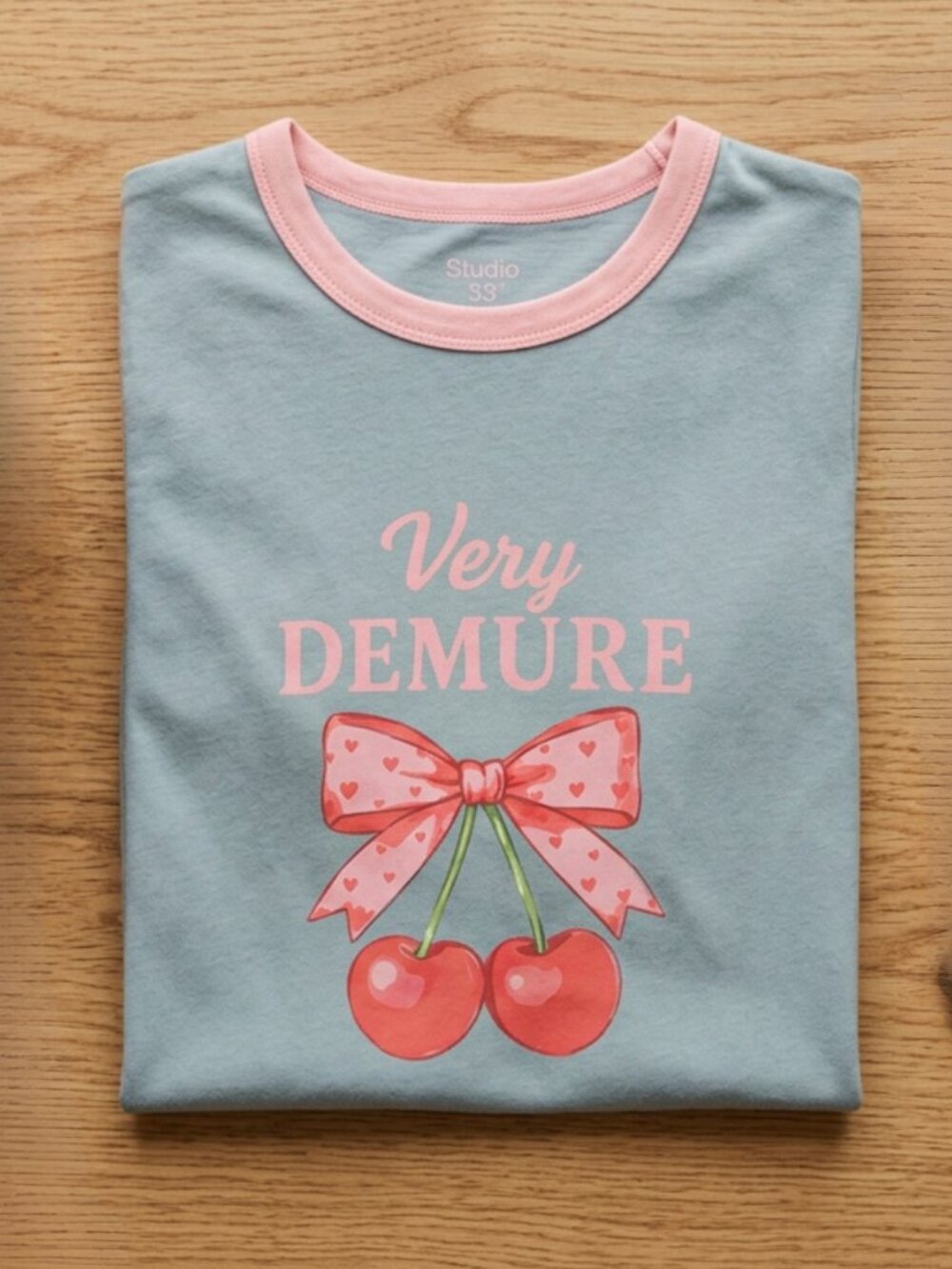 Studio 33 Women’s Very Demure Cherry Bow Graphic Ringer T-Shirt S-XL